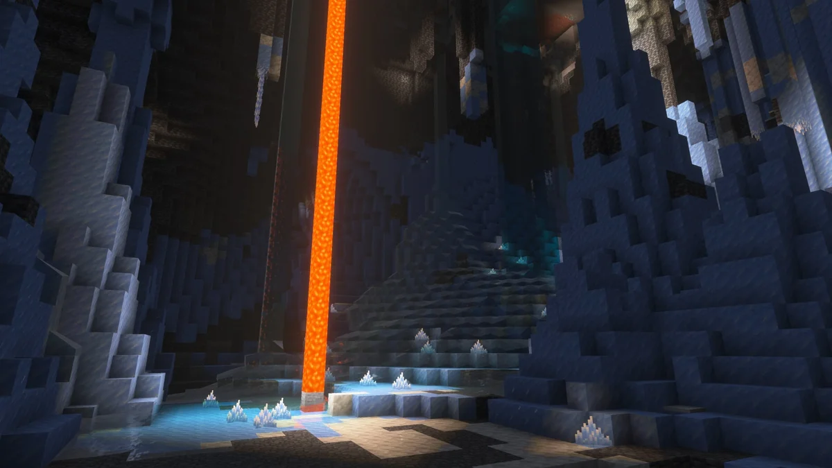Official Minecraft preview image showing an ice cave with packed ice, hanging icicles and a lavafall